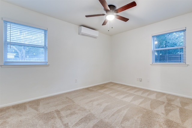 carpeted spare room featuring a wall mounted air conditioner and ceiling fan