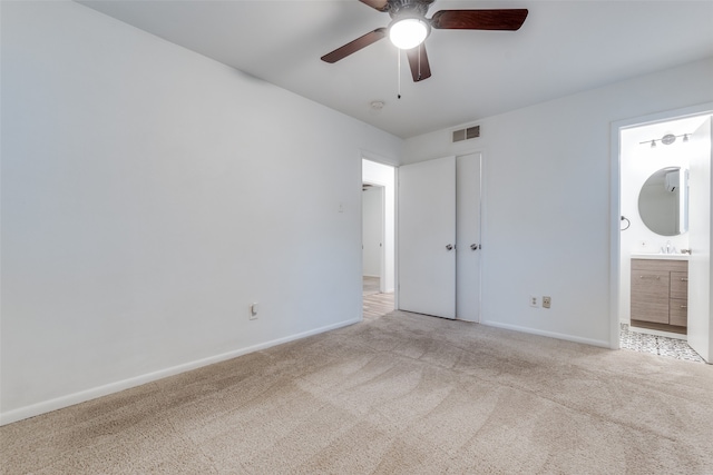 unfurnished bedroom featuring sink, ceiling fan, connected bathroom, and light colored carpet