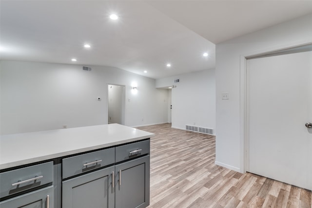 kitchen with gray cabinets and light hardwood / wood-style flooring