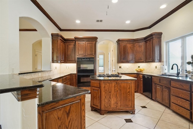 kitchen with kitchen peninsula, crown molding, sink, black appliances, and dark stone countertops