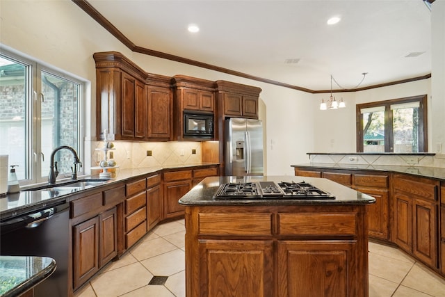 kitchen featuring black appliances, a notable chandelier, a kitchen island, and ornamental molding