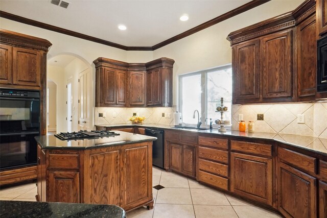 kitchen featuring a center island, black appliances, crown molding, sink, and light tile patterned floors