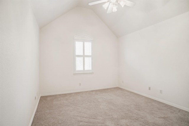 carpeted empty room with ceiling fan and lofted ceiling