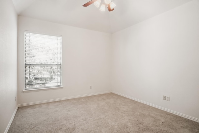 spare room featuring ceiling fan and light colored carpet