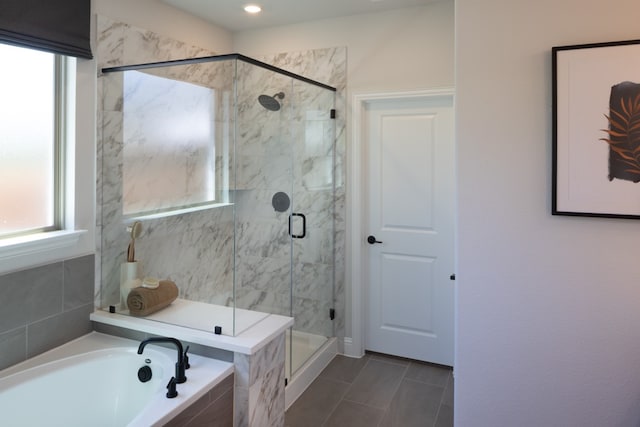 bathroom featuring plus walk in shower and tile patterned flooring