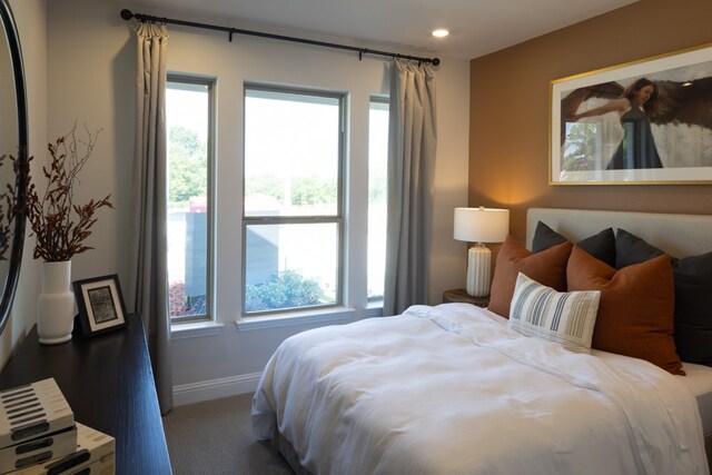 bedroom featuring carpet flooring and multiple windows