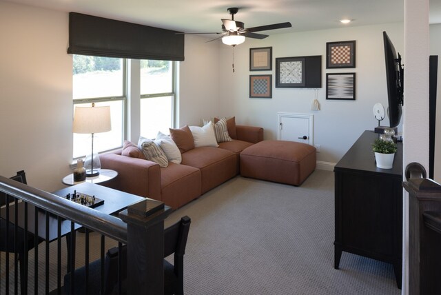 living room with ceiling fan and light colored carpet