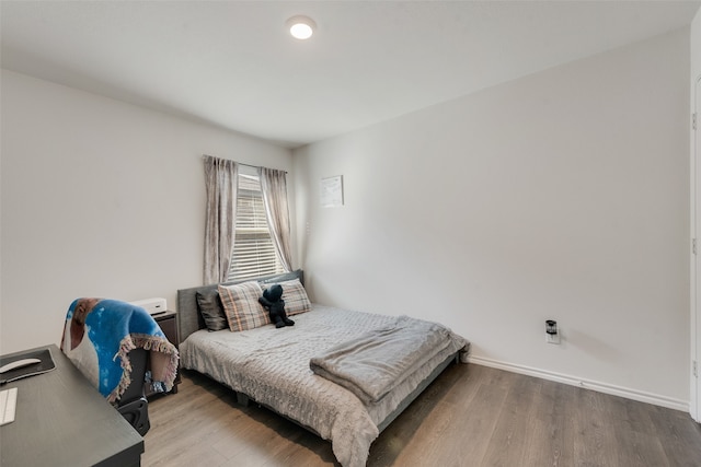 bedroom with hardwood / wood-style flooring