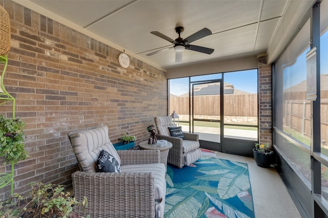 unfurnished sunroom with ceiling fan