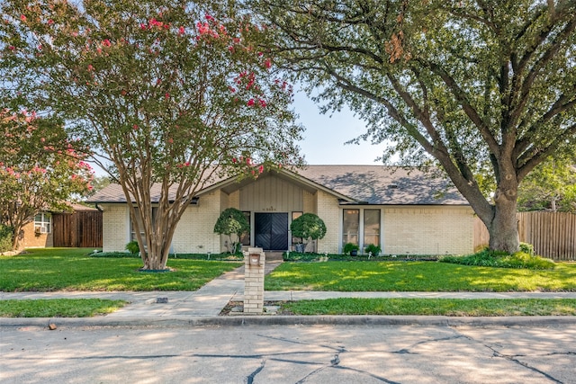 ranch-style home featuring a front yard