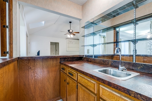 kitchen with sink, vaulted ceiling, and ceiling fan