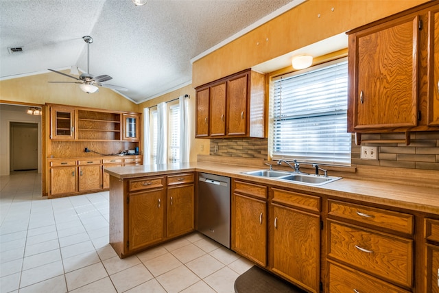 kitchen with dishwasher, kitchen peninsula, lofted ceiling, and plenty of natural light