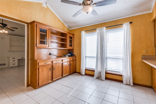 kitchen with a wealth of natural light, a textured ceiling, and light tile patterned flooring