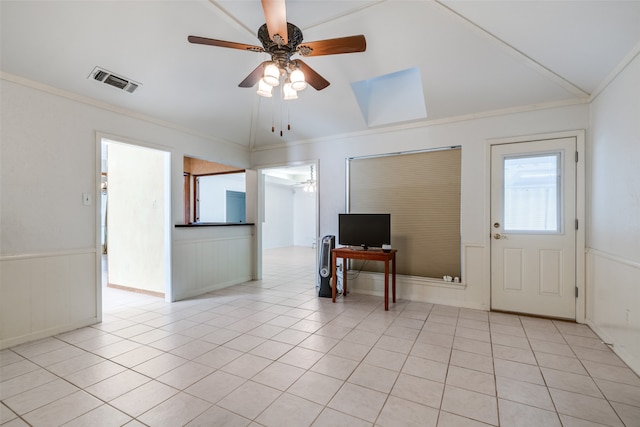 entryway with ceiling fan, lofted ceiling, light tile patterned floors, and ornamental molding