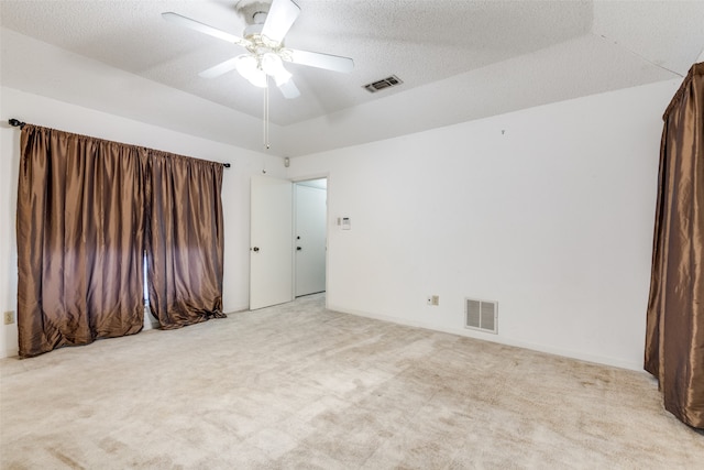 carpeted spare room with a textured ceiling and ceiling fan