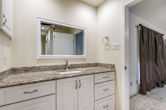 bathroom with vanity and a textured ceiling