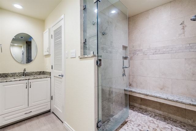 bathroom with vanity and a shower with shower door