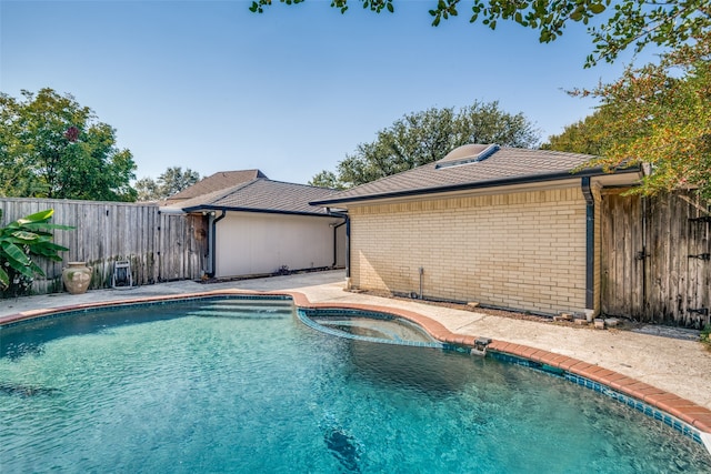 view of swimming pool featuring a hot tub