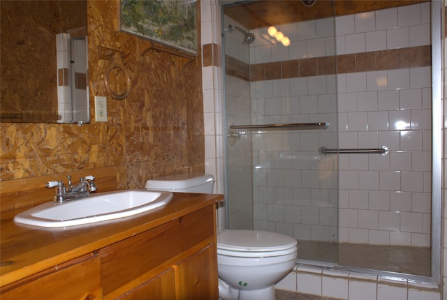 bathroom with vanity, walk in shower, toilet, and tasteful backsplash