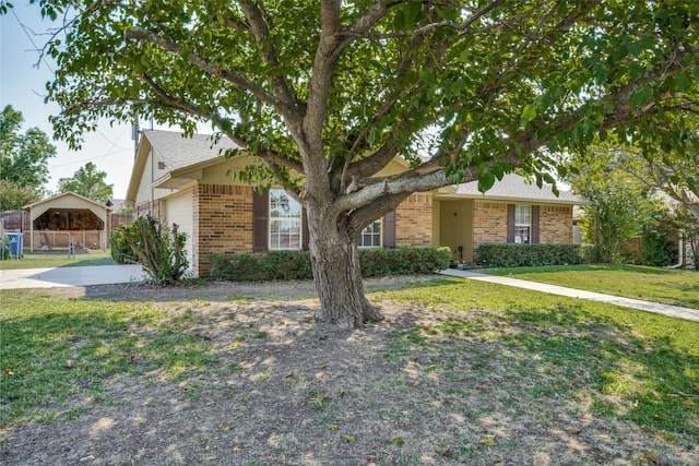 single story home featuring a garage and a front lawn