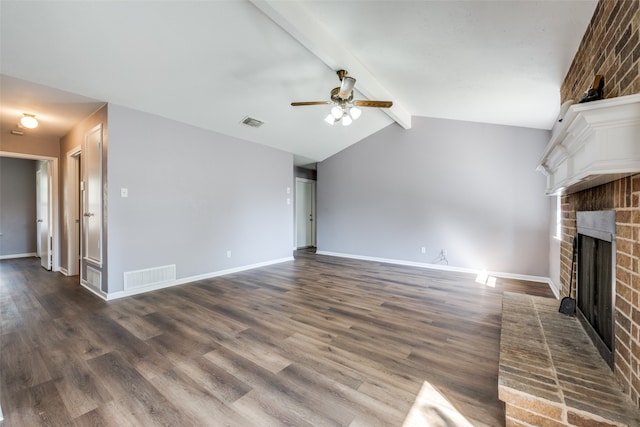 unfurnished living room featuring lofted ceiling with beams, dark hardwood / wood-style floors, a brick fireplace, and ceiling fan