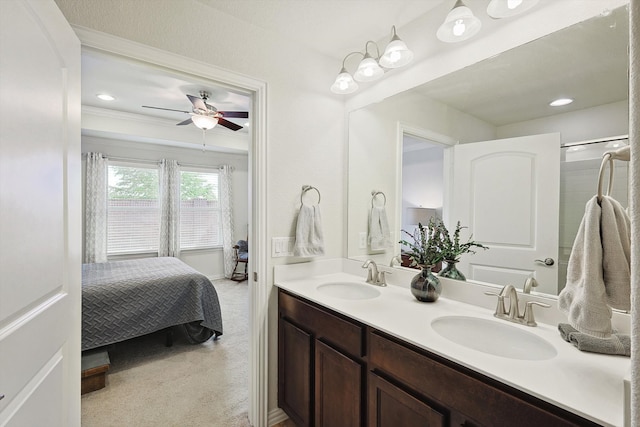 bathroom with ceiling fan, vanity, and ornamental molding