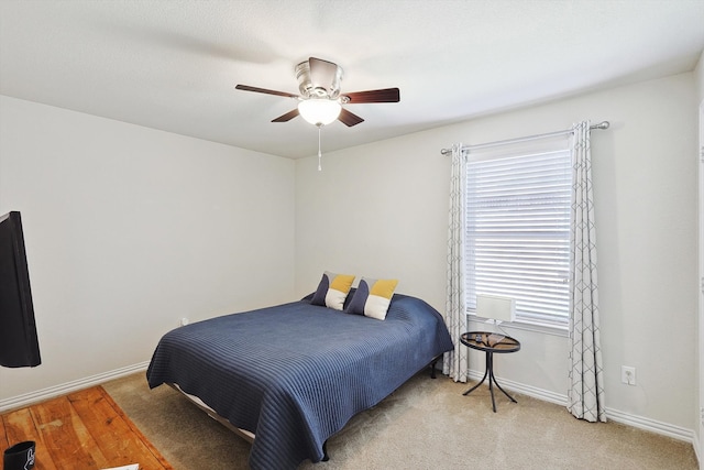 bedroom with light carpet and ceiling fan