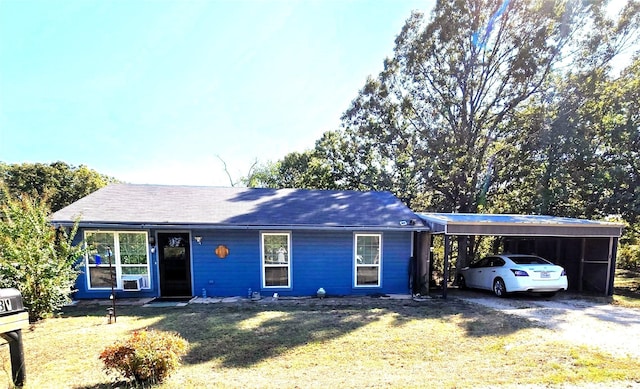 single story home with a front yard and a carport