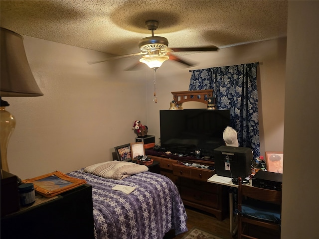 bedroom with ceiling fan, a textured ceiling, and hardwood / wood-style floors