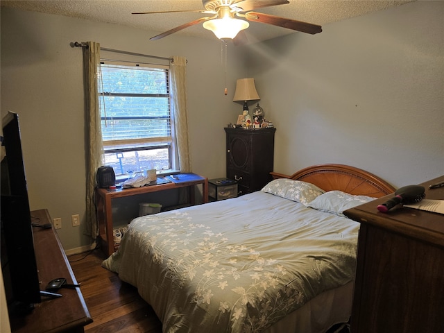 bedroom featuring a textured ceiling, ceiling fan, and dark hardwood / wood-style flooring