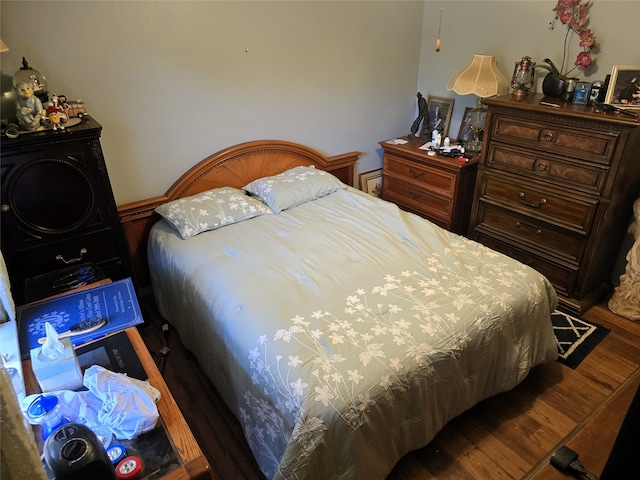 bedroom with hardwood / wood-style flooring