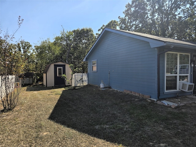 view of home's exterior with a yard and a storage unit