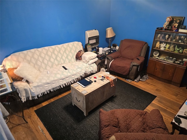 living room featuring hardwood / wood-style flooring and heating unit