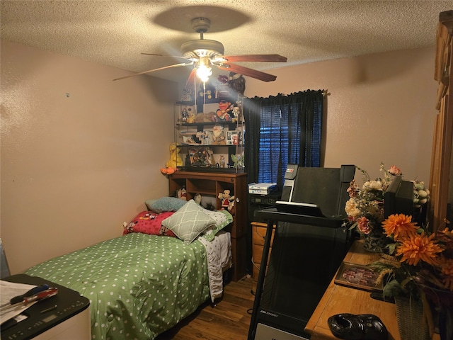 bedroom with ceiling fan, dark hardwood / wood-style floors, and a textured ceiling