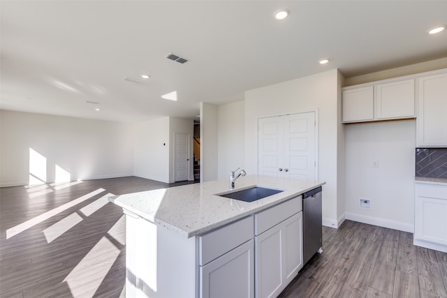 kitchen featuring white cabinetry, dishwasher, sink, and a kitchen island with sink