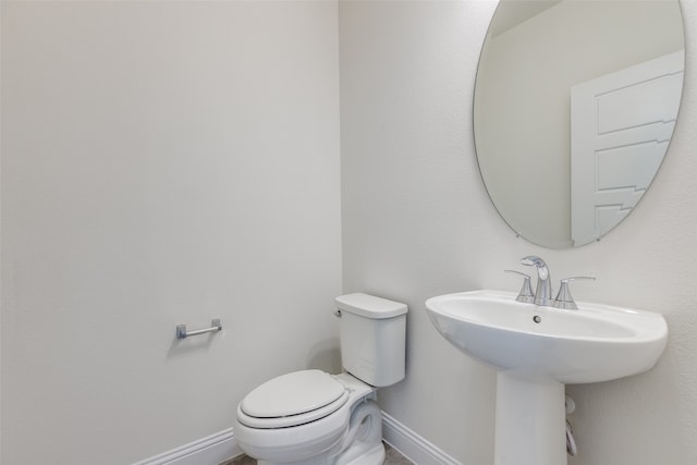 bathroom featuring toilet and sink