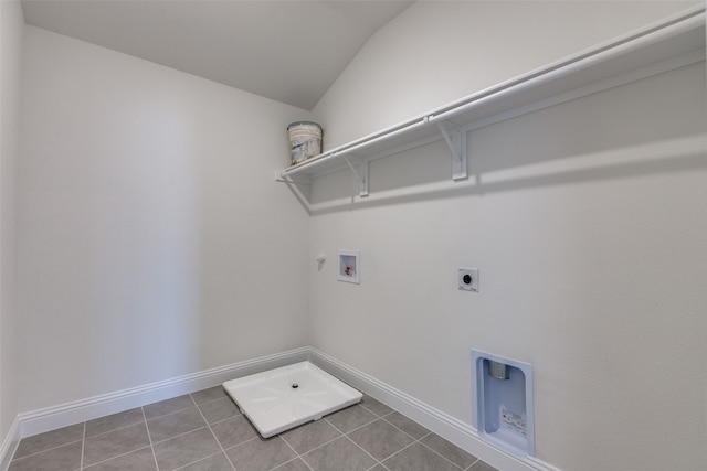 washroom with hookup for an electric dryer, washer hookup, tile patterned flooring, and hookup for a gas dryer