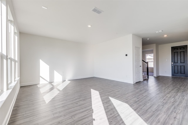 unfurnished living room with light hardwood / wood-style floors and a wealth of natural light