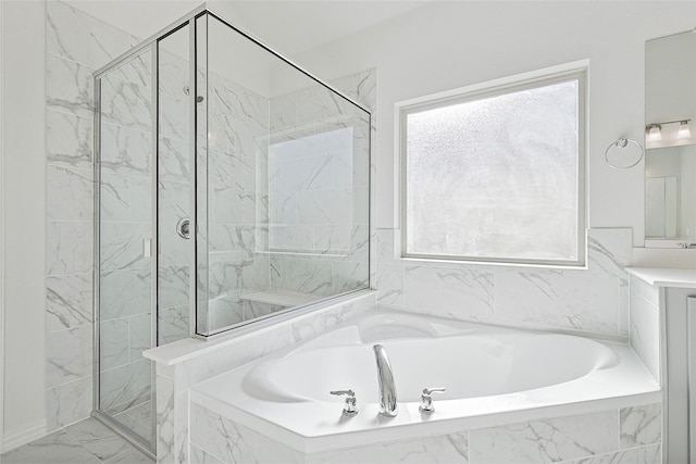 bathroom featuring shower with separate bathtub and a healthy amount of sunlight