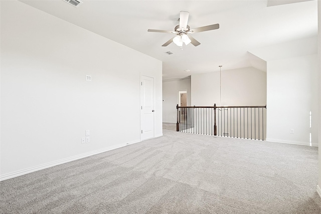 carpeted spare room featuring ceiling fan and lofted ceiling