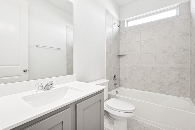 full bathroom featuring vanity, toilet, and tiled shower / bath