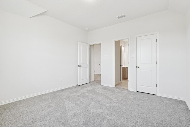 unfurnished bedroom featuring light carpet