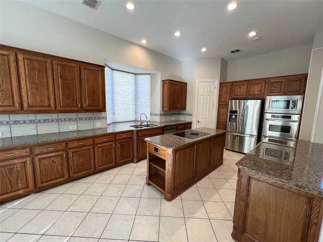 kitchen featuring sink, stainless steel dishwasher, dark stone countertops, a chandelier, and black electric stovetop