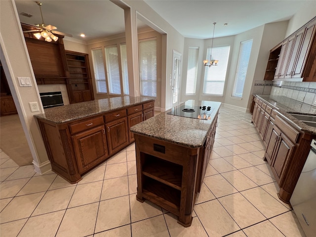 unfurnished living room featuring ceiling fan, ornamental molding, and light tile patterned floors