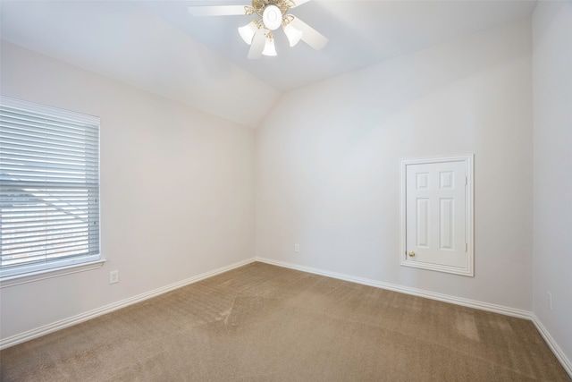 carpeted spare room with ceiling fan and lofted ceiling