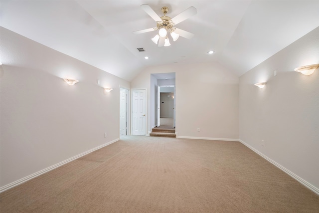 interior space with ceiling fan, light carpet, and vaulted ceiling