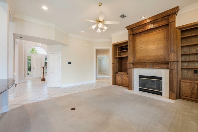 kitchen featuring pendant lighting, dark stone counters, crown molding, black electric cooktop, and light tile patterned flooring