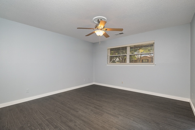 empty room featuring ceiling fan, a textured ceiling, and dark wood-type flooring