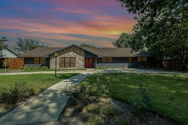 ranch-style home featuring a lawn