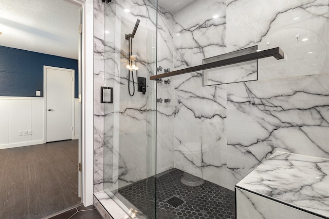 bathroom featuring walk in shower and wood-type flooring